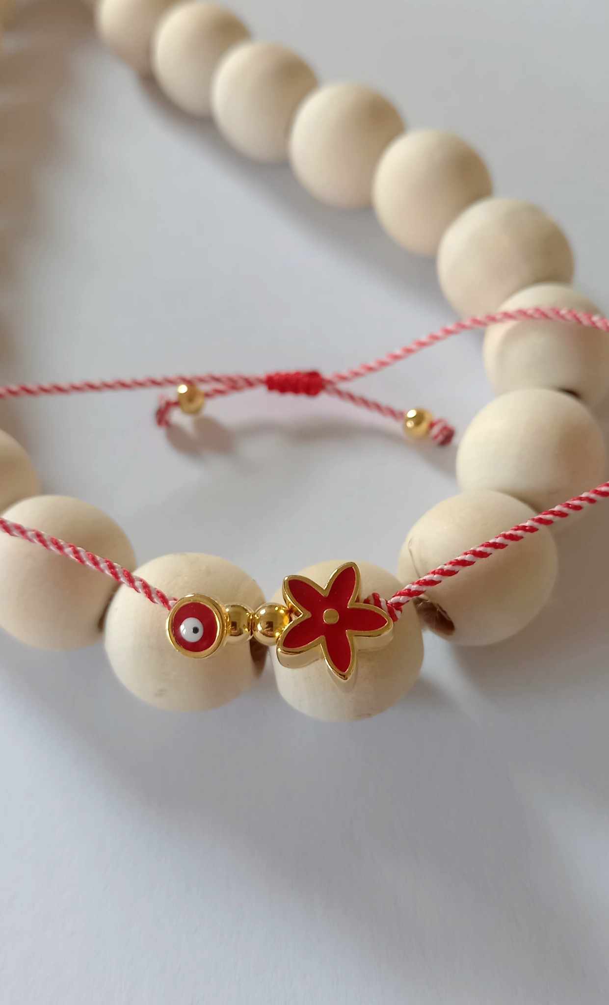 Χειροποίητο βραχιόλι μαρτάκι με επιχρυσωμένο λουλούδι και μάτι