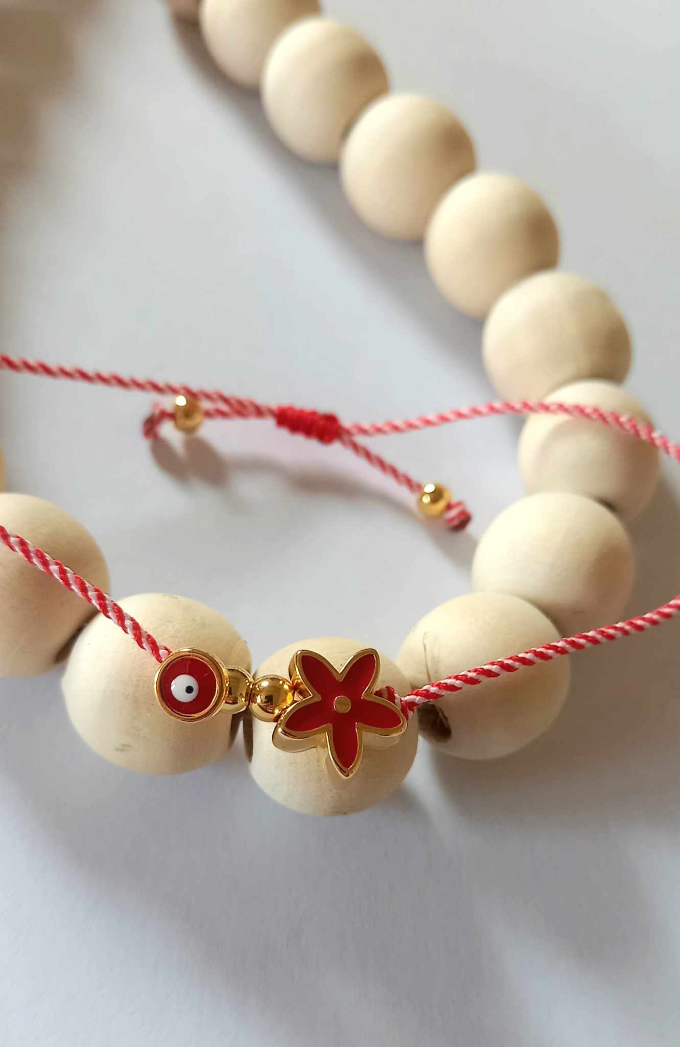 Χειροποίητο βραχιόλι μαρτάκι με επιχρυσωμένο λουλούδι και μάτι